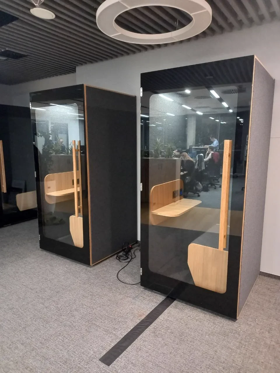 Cabine NINA noire avec banquette dans un environnement bancaire